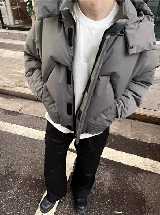 Person wearing a gray winter jacket on a street