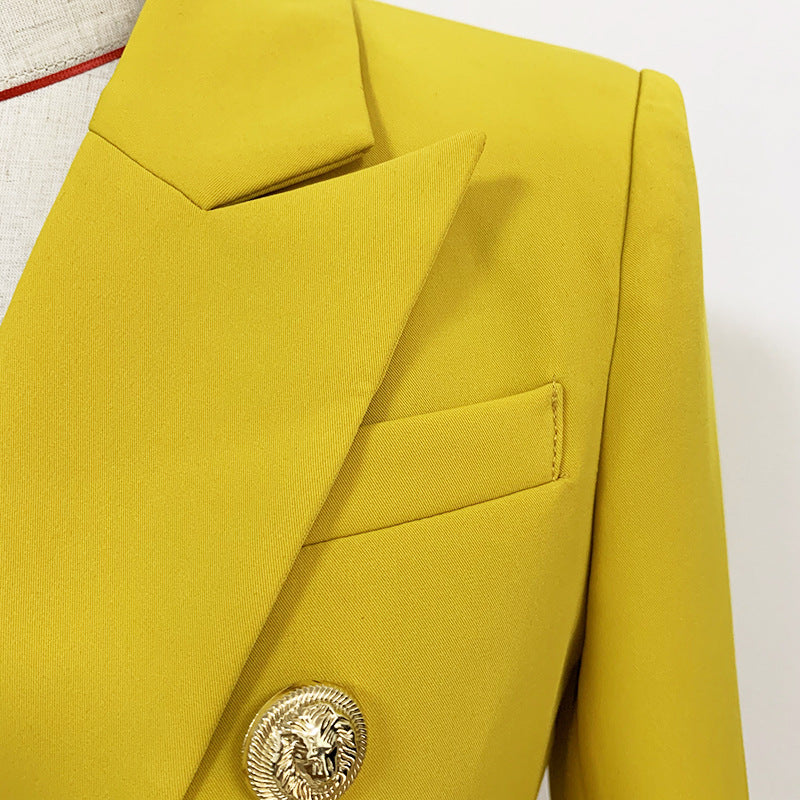 Close-up of a mustard yellow blazer with a gold button on a white background