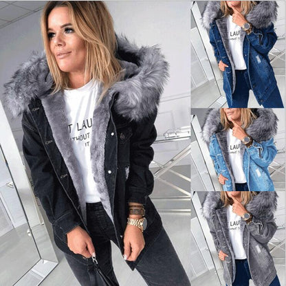 Woman wearing a black denim jacket with gray fur hood in a store setting.