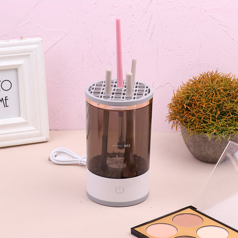 Humidifier on a desk with a pink straw and makeup palette in the background