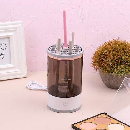 Humidifier on a desk with a pink straw and makeup palette in the background