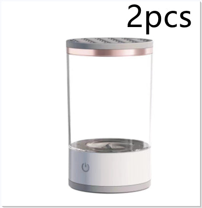 Two clear cylindrical containers with metallic tops on a white background