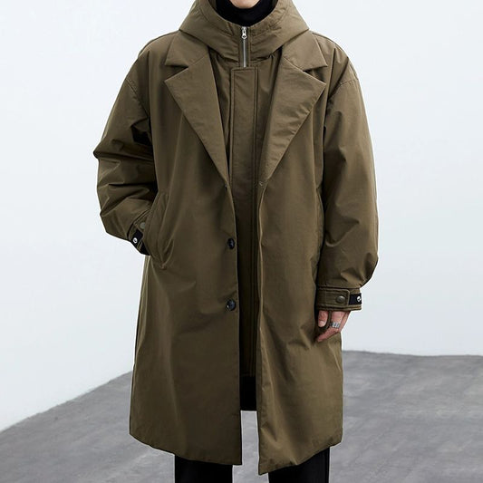Long olive green coat on a neutral background