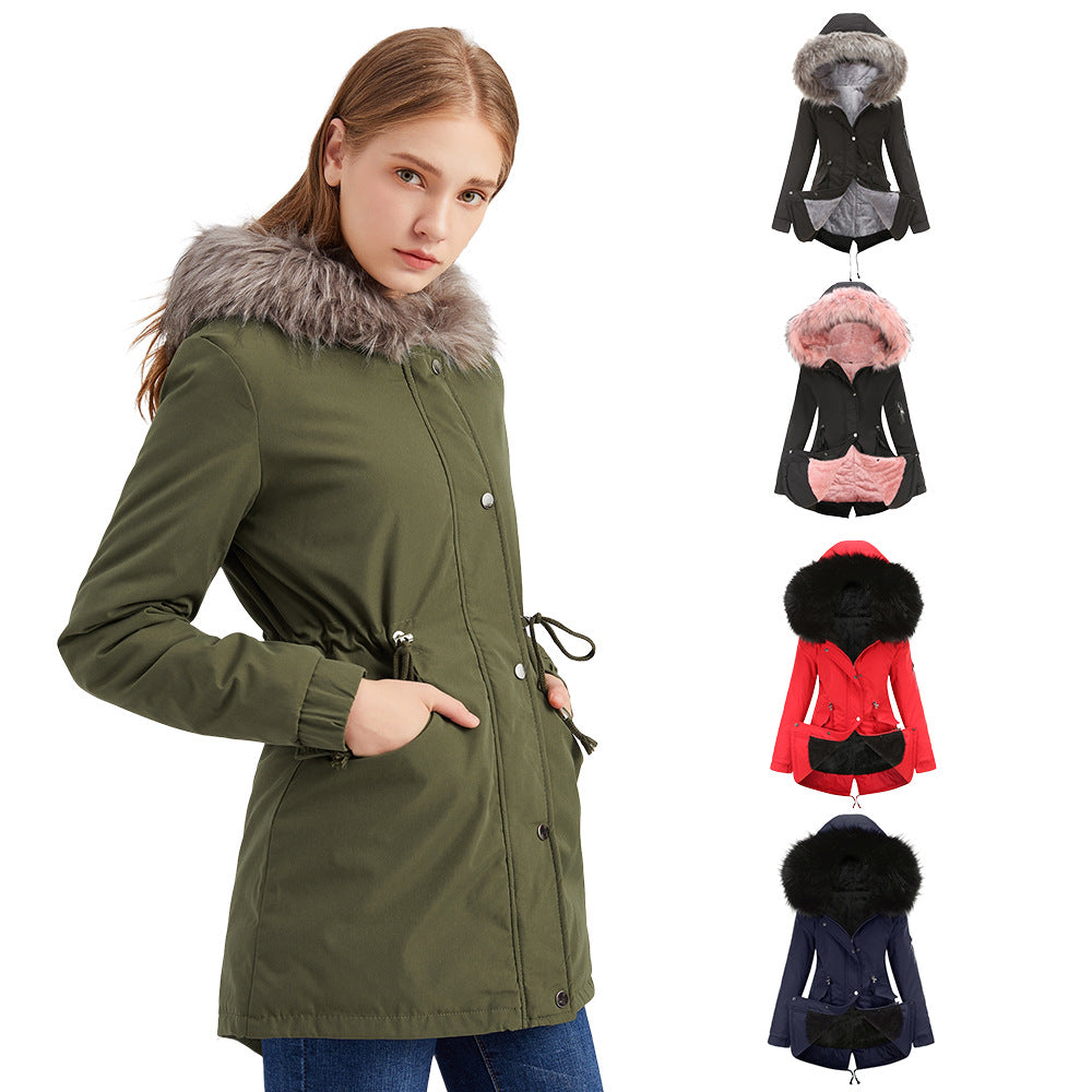 Woman wearing a green parka with fur hood, surrounded by color options on hangers.