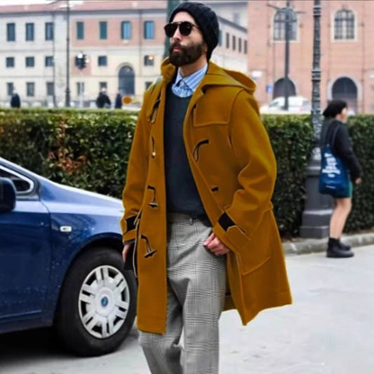 Man wearing a mustard yellow coat on a city street