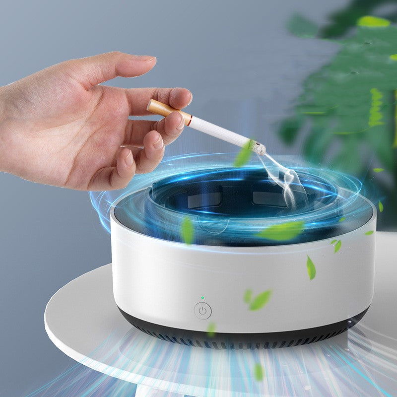 Hand placing a cigarette into a modern ashtray with a blue light and green leaves.