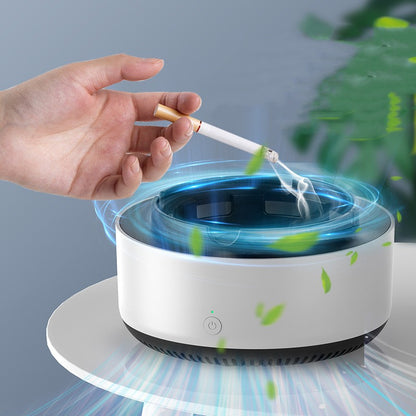 Hand placing a cigarette into a modern ashtray with a blue light and green leaves.