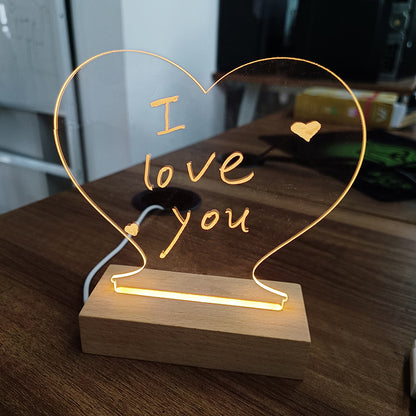 Heart-shaped LED lamp with 'I love you' text on a wooden base