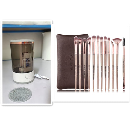 Set of rose gold makeup brushes with a brown pouch and a clear cylindrical device on a white background.