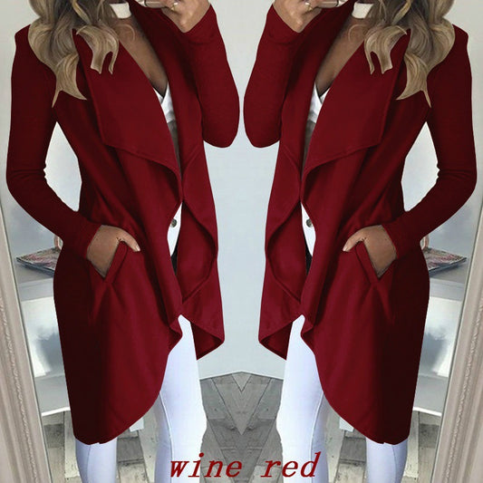 Wine red coat worn by a person in front of a mirror.